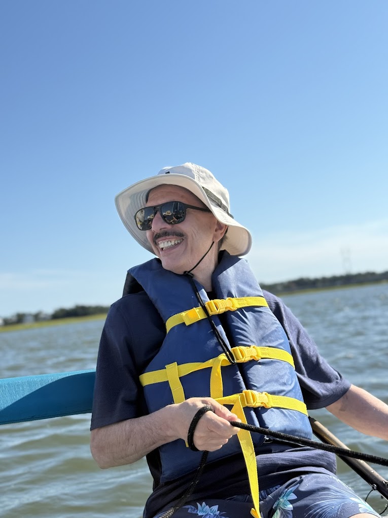 Smiling guest at the helm of a Hobie Cat in Emerald Isle